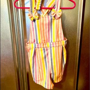 Adorable shorts overalls with matching bow.